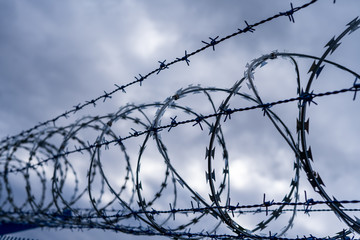Prison barbed wire. Prison fence. Strict punishment for crimes
