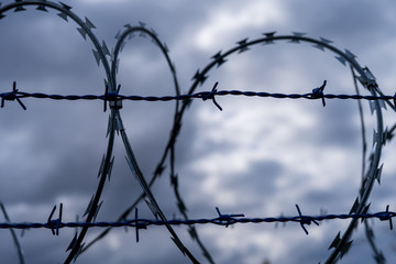 Prison barbed wire. Prison fence. Strict punishment for crimes