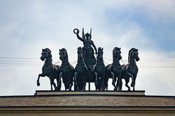 Moscow, Russia, june 2018: Sculptural group on top of the triumphal arch, six horses with the goddess of victory in the chariot a background of dramatic overcast sky (editorial)