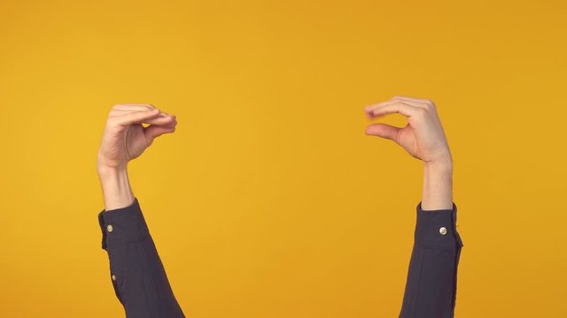 Man hands showing bla bla gesture over yellow background. Two hands sign