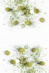 Fototapeta na wymiar Olives sprinkled with herbs on a white background. 