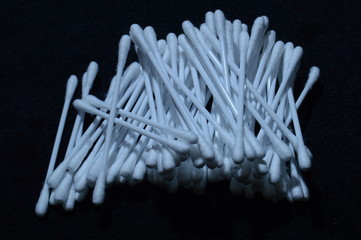 cotton swabs on a black background