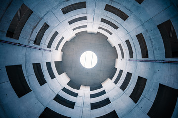 Empty concrete spiral space building, Natural light from ceiling, concrete windows, bottom-up perspective