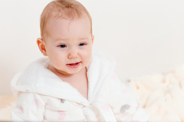 Caucasian baby girl in a white coat