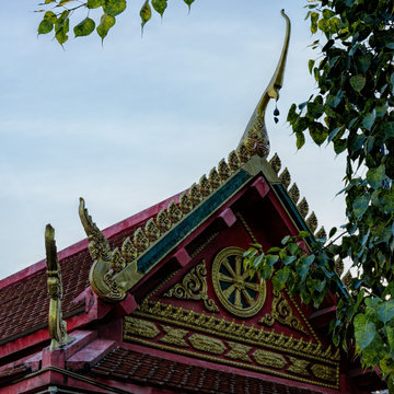 Detail of a newly built Buddhist Ku Cheng Tse Temple with intricately carved and painted gable and gilt dragon finial decorating. Seberang Jaya, Penang, Malaysia.