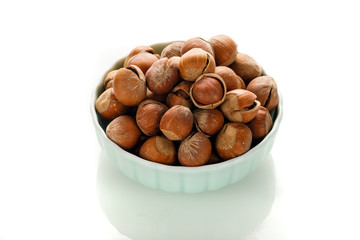 Hazelnut nuts on a white board