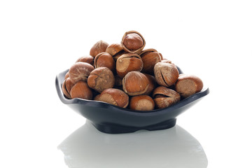 Hazelnut nuts on a white board