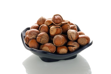 Hazelnut nuts on a white board