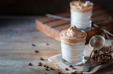 Iced frothy drink Dalgona Coffee, trend korean drink latte espresso with coffee. Gray concrete background.