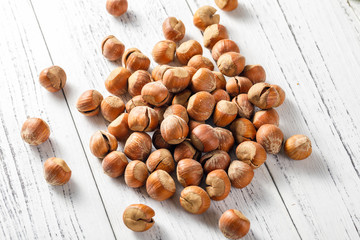 Hazelnut nuts on a white board