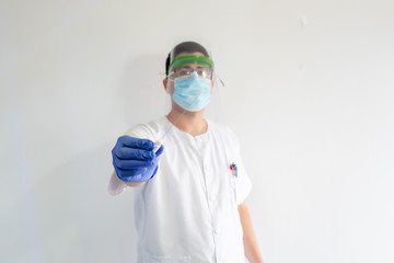 Doctor / Nurse with face shield has a nasal smear for the covid19. Nasal mucus test for viral...