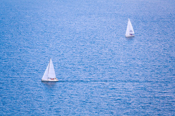 Two sailing boats on the blue water