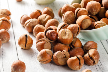 Hazelnut nuts on a white board