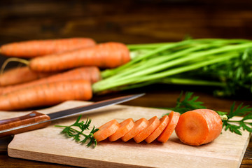 Fresh raw sliced carrot on a cutting board