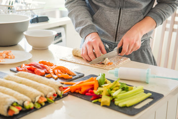 Caucasian man preparing homemade sushi rolls. Forming sushi. The steps for creating sushi with...