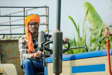 indian farmer with tractor at field