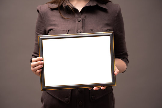 Blank Diploma Certificate Mockup. Woman With Empty Photo Frame With Copy Space Close Up.