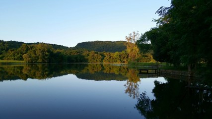 Fototapeta na wymiar Reflection Of Trees In Lake Against Clear Sky