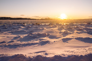 View of Quebec city over the frozen river, sunset time