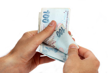 Turkish lira coins in a row on hundred banknotes.