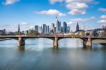 Fototapeta premium Frankfurt, Germany - March 31, 2020: frankfurt skyline view with ignas bubis bridge during daytime