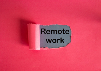 The text remote work appearing behind torn pink paper.