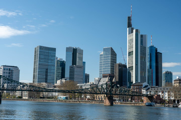 Obraz premium Frankfurt, Germany - March 31, 2020: frankfurt skyline view from main riverside in springtime