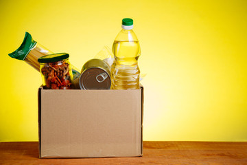 Food Donation concept. Donation Box With food For Donation On Yellow Backround. Assistance To The...