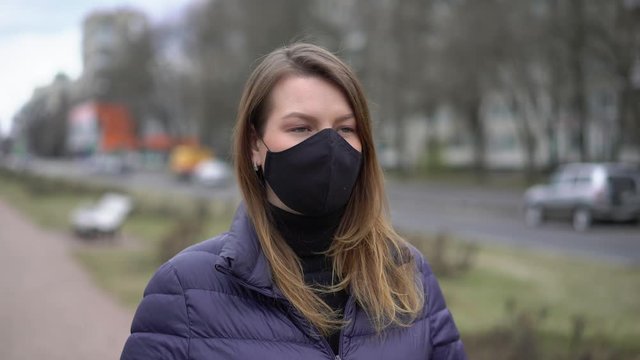 Woman in face protective mask in a city. Epidemic pandemic covid-19 coronavirus
