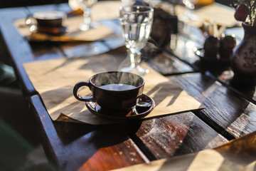 Coffee mug on the table to the cafe