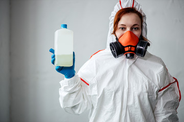 professional female disinfector holding disinfectant fluid in hands. people fight with coronavirus COVID-19, get rid of bacterias and infections