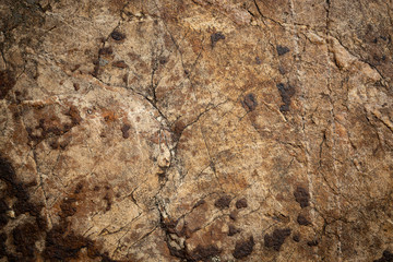 brown old stone background inlaid with bits of rust and abstract shapes