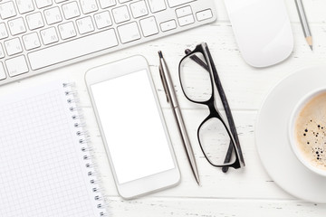 Office workplace with computer, notepad and smartphone