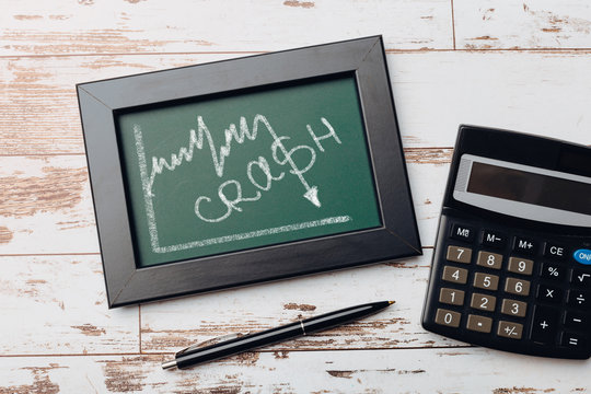 charts of economics and stock markets on a chalk board. financial crisis concept.