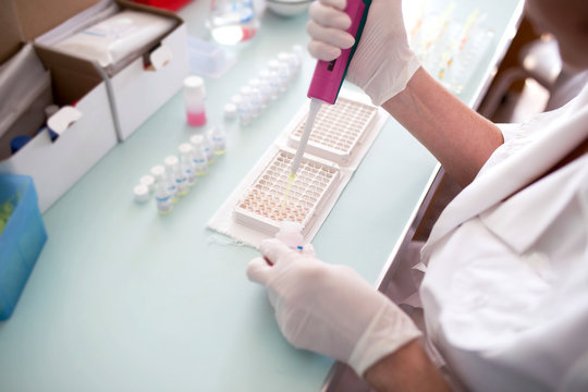 researcher doing research in a lab. Scientist doing biological test in laboratory. Doctor doing medical analysis on machine. Coronavirus COVID-19, Creation of vaccine concept. Close up