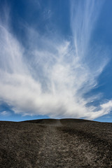 Wispy Clouds Above Volcanic Trail