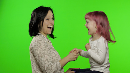 Mother and little daughter playing rock paper scissors. Chroma Key. Leisure game