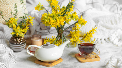 Spring still life with a Cup of tea and flowers .