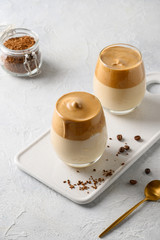 Two glasses of Dalgona coffee on white background. Vertical shot.