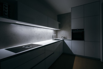 Modern white kitchen of corner shape in minimalist design, during night, with light strip turned...