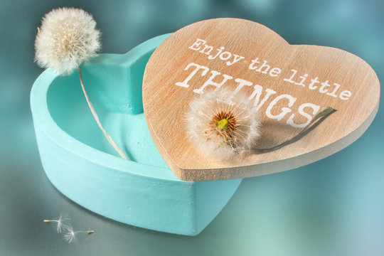 Gift Box In The Form Of Heart With fragile dadelion . with text enjoy the little tings