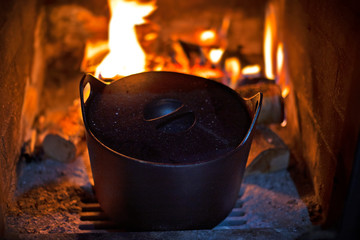 a pot in fireplace . cooking food in fireplace 