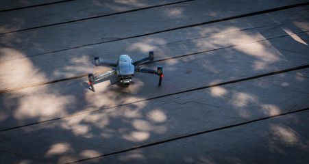Obraz premium drone landed on wooden deck after scenic flight 