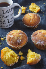Muffins with coffee on dark background