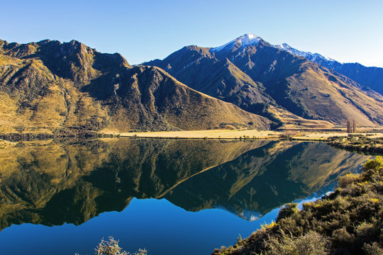 Moke Lake on the South Island of New Zealand. Photograph taken in autumn. Beautiful mountains and lake with reflections near Queenstown. Soft focus.