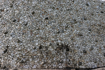 A close up of the white quartz stone façade that surrounds the front of Newgrange megalithic passage tomb in the Boyne Valley, Meath, Ireland.