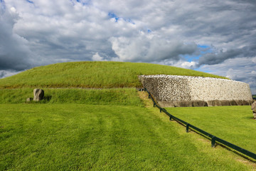 The dazzling white quartz stone façade at the front of Newgrange megalithic passage tomb contrasts...