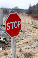 stop sign on the road in the countryside close up