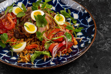 Food dish. Beans, rice, meat, salad, egg. Rustic wood background.