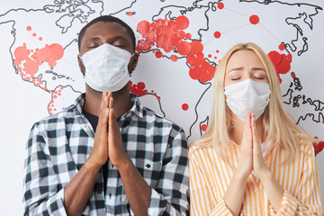 portrait of two diverse people hoping for coronavirus pandemic ending, people protect themselves...